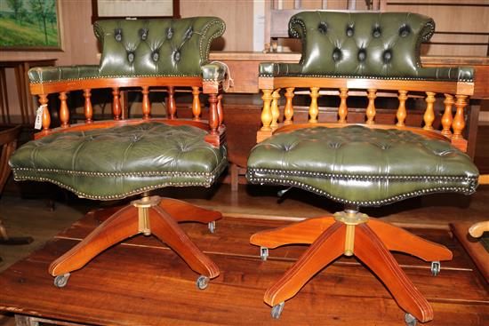 A pair of green leather upholstered revolving tub chairs, W.62cm